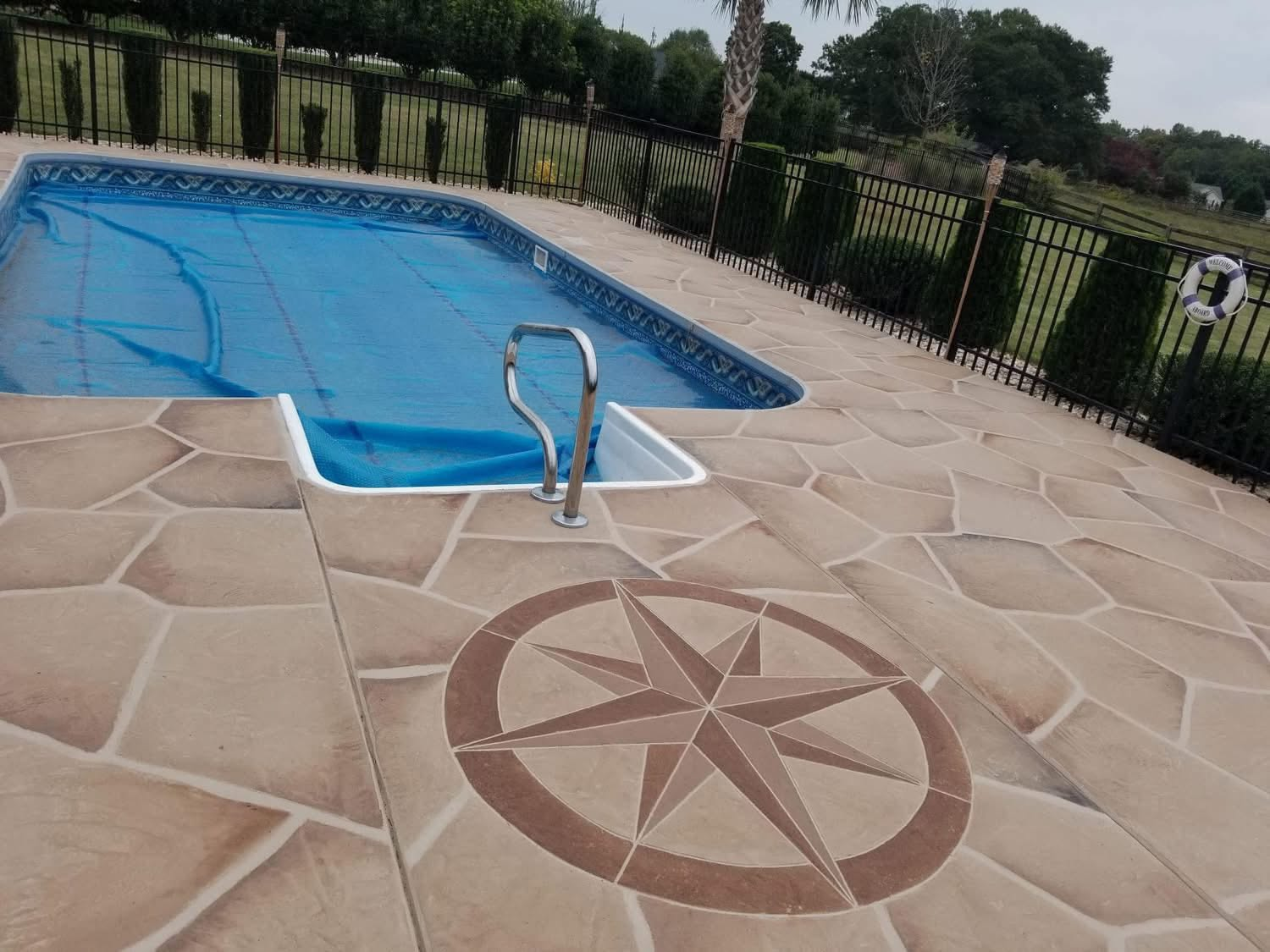 Stamped pool deck with a custom compass rose medallion in Greenville, SC